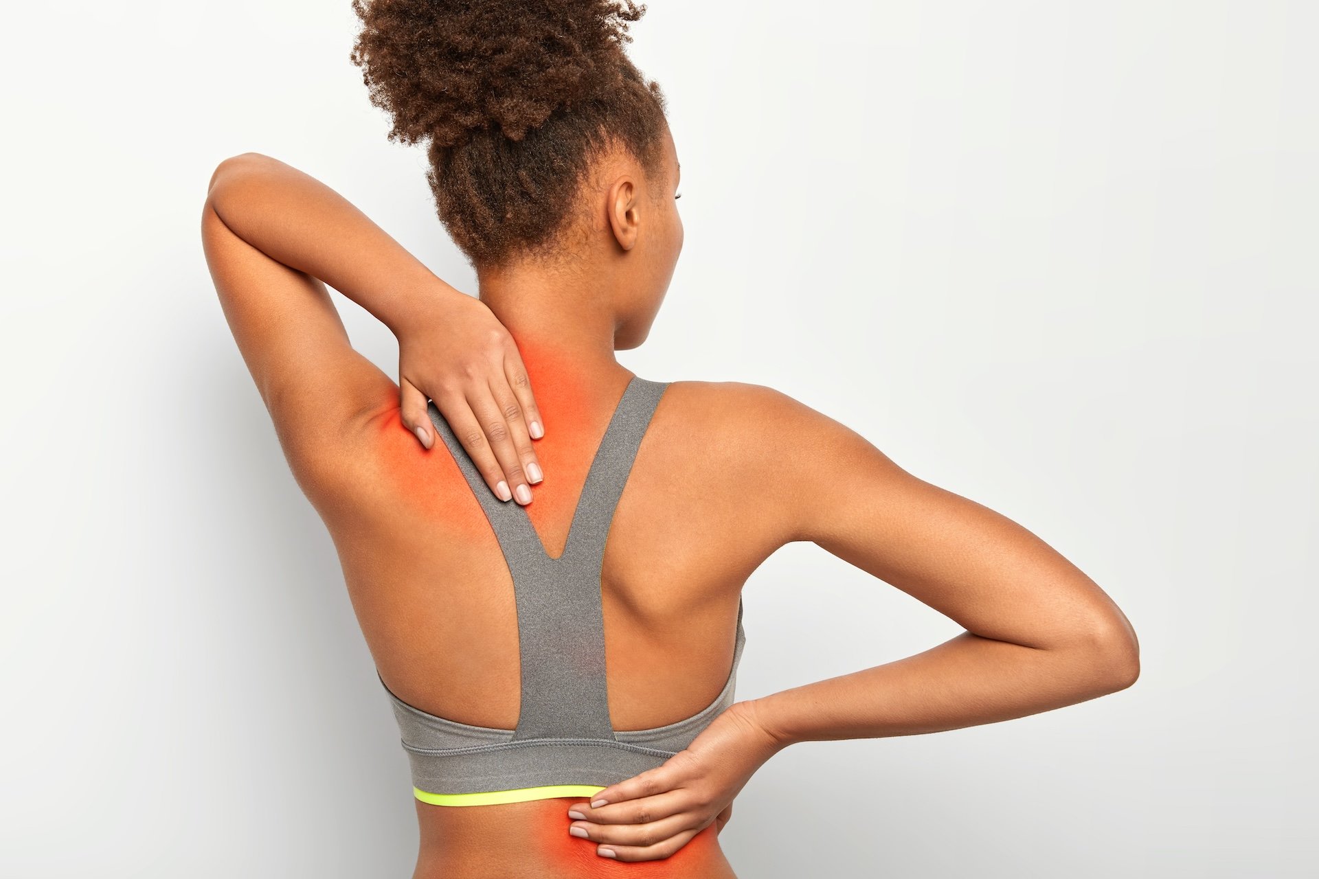 Woman touching her neck and upper back where inflammation causes pain
